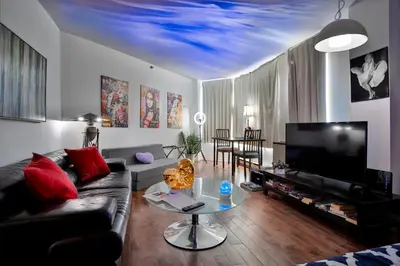 a living room with a couch and a tv at Beautiful APARTMENT - GORGEOUS VIEW of the city - 7 MINUTE WALK TO METRO - SELF CHECK IN in Montréal