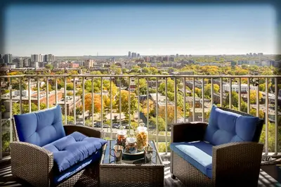 a balcony with chairs and a view of a city at Beautiful APARTMENT - GORGEOUS VIEW of the city - 7 MINUTE WALK TO METRO - SELF CHECK IN in Montréal