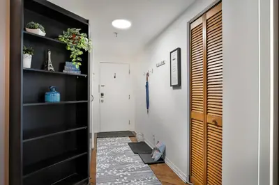 a hallway with black shelves and a door at Beautiful APARTMENT - GORGEOUS VIEW of the city - 7 MINUTE WALK TO METRO - SELF CHECK IN in Montréal