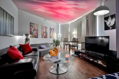 a living room with a couch and a table at Beautiful APARTMENT - GORGEOUS VIEW of the city - 7 MINUTE WALK TO METRO - SELF CHECK IN in Montréal