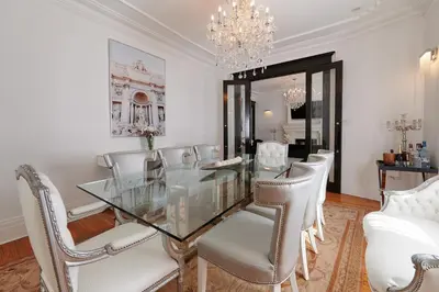 a dining room with a glass table and chairs at Villa Dante By Denstays in Montréal