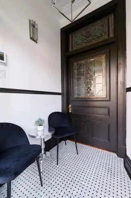 a room with two chairs and a door and a table at Villa Dante By Denstays in Montréal