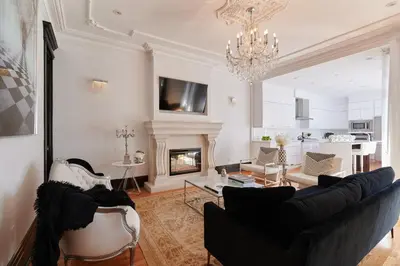 a living room with a couch and a fireplace at Villa Dante By Denstays in Montréal