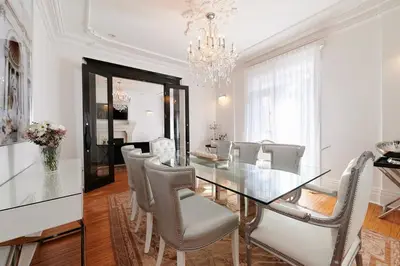 a dining room with a glass table and chairs at Villa Dante By Denstays in Montréal