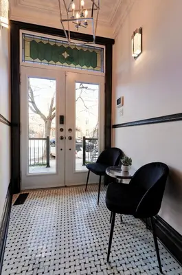 a room with two chairs and a table and a door at Villa Dante By Denstays in Montréal
