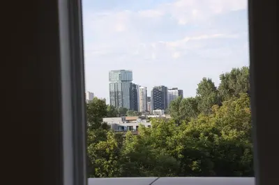 a view of a city skyline from a window at Sunset Apartment in Montréal