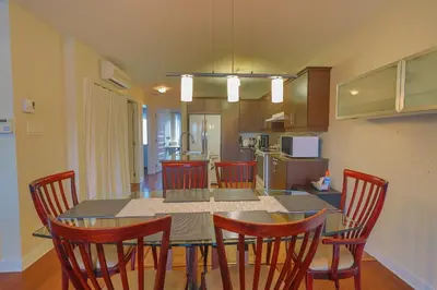 a kitchen with a dining room table and chairs at Sunset Apartment in Montréal