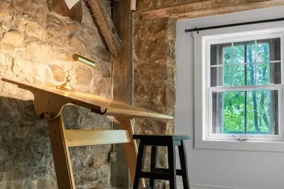 a room with a wooden counter and a window at L'Artisan - Vieux-Terrebonne in Terrebonne