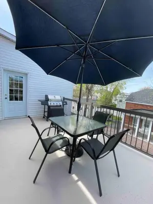 a table and chairs with an umbrella on a patio at Le paisible ensoleillé ! beau 51/2 à Drummondville in Drummondville