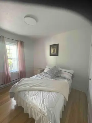 a bedroom with a bed in a room with a window at Le paisible ensoleillé ! beau 51/2 à Drummondville in Drummondville