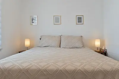 a bedroom with a large bed with two lamps at Le Eleven 55 - Billard - 5 lits in Trois-Rivières