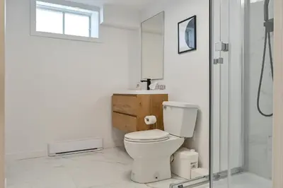 a bathroom with a toilet and a sink and a shower at Le Eleven 55 - Billard - 5 lits in Trois-Rivières