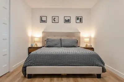 a bedroom with a bed with two night stands and two lamps at Le Eleven 55 - Billard - 5 lits in Trois-Rivières