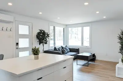 a kitchen and living room with a couch and a table at Le Eleven 55 - Billard - 5 lits in Trois-Rivières
