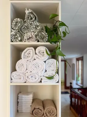 a shelf filled with rolled towels in a room at Chez Léo par Maison Dudley in Lac-Mégantic