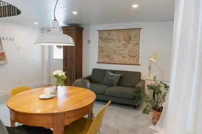 a living room with a table and a couch at Le Central par Maison Dudley in Lac-Mégantic