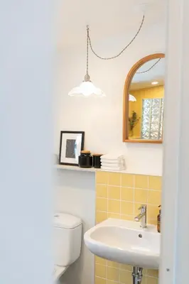 a bathroom with a toilet and a sink and a mirror at Le Central par Maison Dudley in Lac-Mégantic