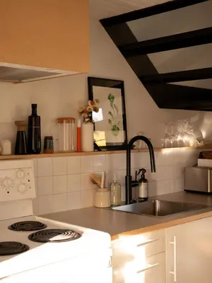 a kitchen with a sink and a stove top oven at Le Central par Maison Dudley in Lac-Mégantic