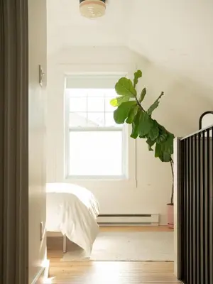 a bedroom with a bed and a window at Le Loft par Maison Dudley in Lac-Mégantic