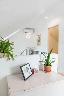 a table with a picture and a plant on it at Le Loft par Maison Dudley in Lac-Mégantic
