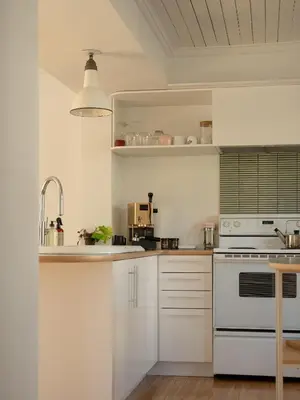 a kitchen with white cabinets and a sink at Le Boulevard par Maison Dudley in Lac-Mégantic