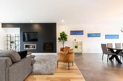 a living room with a couch and a table at Le Memph Hirondelle spacious comfortable condo cottage eco responsible 3 bedrooms - hot tub & pool Memphrémagog Lake in Magog-Orford