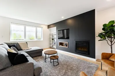 a living room with a couch and a fireplace at Le Memph Hirondelle spacious comfortable condo cottage eco responsible 3 bedrooms - hot tub & pool Memphrémagog Lake in Magog-Orford