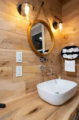 a bathroom with a white sink and a mirror at Chalet Memphrémagog Ski Spa, Étang in Mansonville