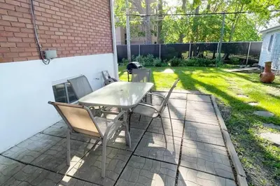 a table and chairs sitting on a patio at Stylish and luxurious apartment basement unit in Longueuil