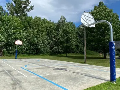 a basketball court with a hoop and a basketball hoop at Relaxez, condo Zen, climatisé, campagne&lacs in Magog-Orford