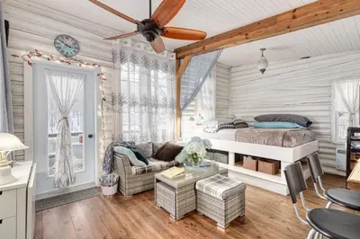 a bedroom with a bed and a couch at Le Perché-sur-la-rivière in Joliette