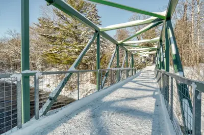 a bridge over the river in the snow at Le Perché-sur-la-rivière in Joliette