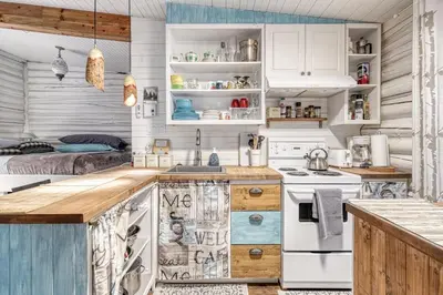 a kitchen with white cabinets and a counter top at Le Perché-sur-la-rivière in Joliette