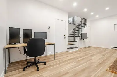 an office with a desk with two monitors and a chair at Top Rated Vacation House Montreal Private Parking in Laval