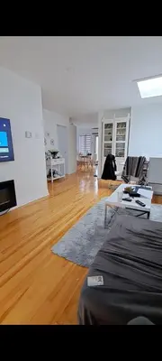 an empty living room with a couch and a tv at Confort in Montréal