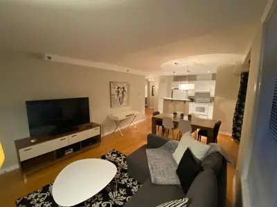 a living room with a couch and a dining room at ApartHotelMontreal by Les Terrasses Saint Urbain 2225I2 in Montréal