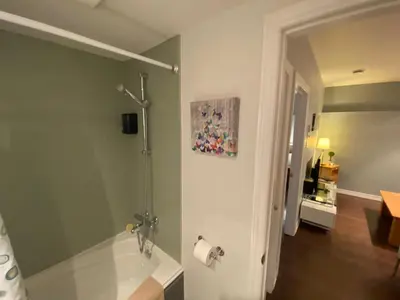 a bathroom with a bath tub and a sink at ApartHotelMontreal by Les Terrasses Saint Urbain 2225I2 in Montréal