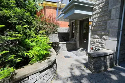 a house with a stone walkway leading to a door at ApartHotelMontreal by Les Terrasses Saint Urbain 2225I2 in Montréal