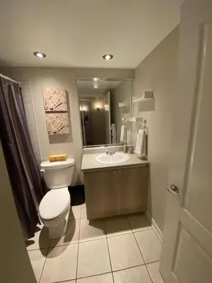 a bathroom with a toilet and a sink at ApartHotelMontreal by Les Terrasses Saint Urbain 2225I2 in Montréal