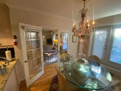 a dining room with a glass table and a chandelier at ApartHotelMontreal by Les Terrasses Saint Urbain 2225I2 in Montréal