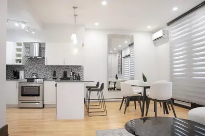 a kitchen and living room with a table and chairs at Chic 1-Bedroom Retreat in Montreal's Vibrant Plateau Mont-Royal Area - Apt 3 in Montréal