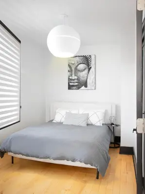 a bedroom with a bed with a black and white headboard at Chic 1-Bedroom Retreat in Montreal's Vibrant Plateau Mont-Royal Area - Apt 3 in Montréal
