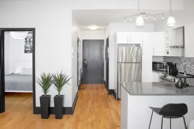 a kitchen and living room with a black and white at Chic 1-Bedroom Retreat in Montreal's Vibrant Plateau Mont-Royal Area - Apt 3 in Montréal