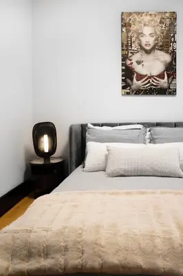 a bedroom with a bed and a picture on the wall at Eat, Explore & Enjoy Downtown Montreal at this Sleek City Escape located in Plateau Mont-Royal - Apt 4 in Montréal