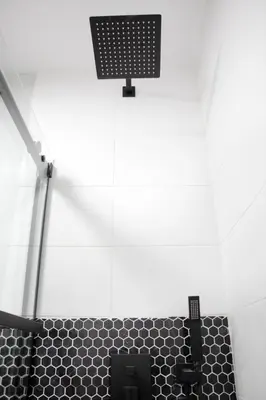 a bathroom with a black and white tiled shower at Eat, Explore & Enjoy Downtown Montreal at this Sleek City Escape located in Plateau Mont-Royal - Apt 4 in Montréal