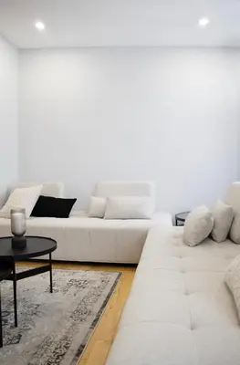 a living room with a white couch and a table at Eat, Explore & Enjoy Downtown Montreal at this Sleek City Escape located in Plateau Mont-Royal - Apt 4 in Montréal