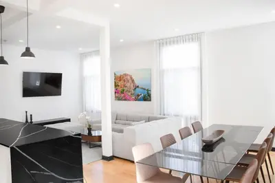 a living room with a glass table and a couch at Upscale 3-Bedroom Entire Unit in the Trendy Plateau Mont-Royal featuring A Magazine-Worthy Kitchen & Opulent Living Spaces - Apt 1 in Montréal