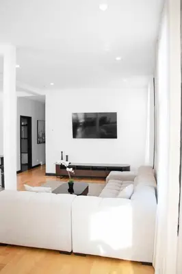 a white living room with a white couch at Upscale 3-Bedroom Entire Unit in the Trendy Plateau Mont-Royal featuring A Magazine-Worthy Kitchen & Opulent Living Spaces - Apt 1 in Montréal