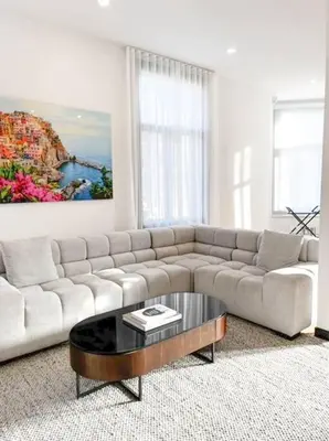a living room with a couch and a coffee table at Upscale 3-Bedroom Entire Unit in the Trendy Plateau Mont-Royal featuring A Magazine-Worthy Kitchen & Opulent Living Spaces - Apt 1 in Montréal