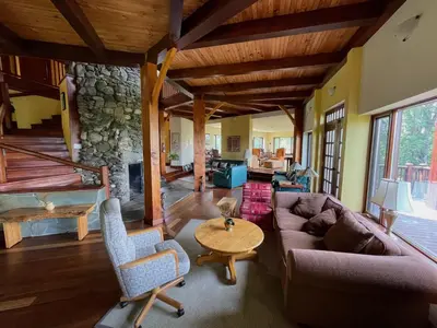 a living room with a couch and a stone fireplace at Sugar Hill Retreat #296692 in Lac-Brome